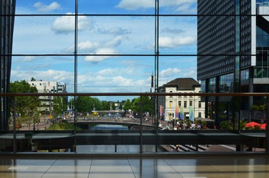 Photo of Beautiful city street with buildings, view through big glass windows