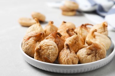Tasty dried figs on light grey marble table, closeup