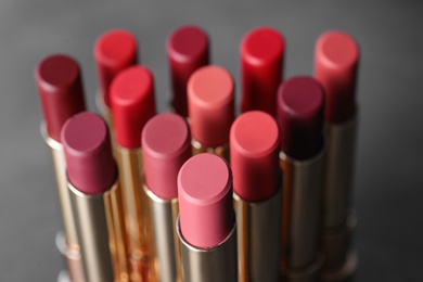 Set of bright lipsticks on grey background