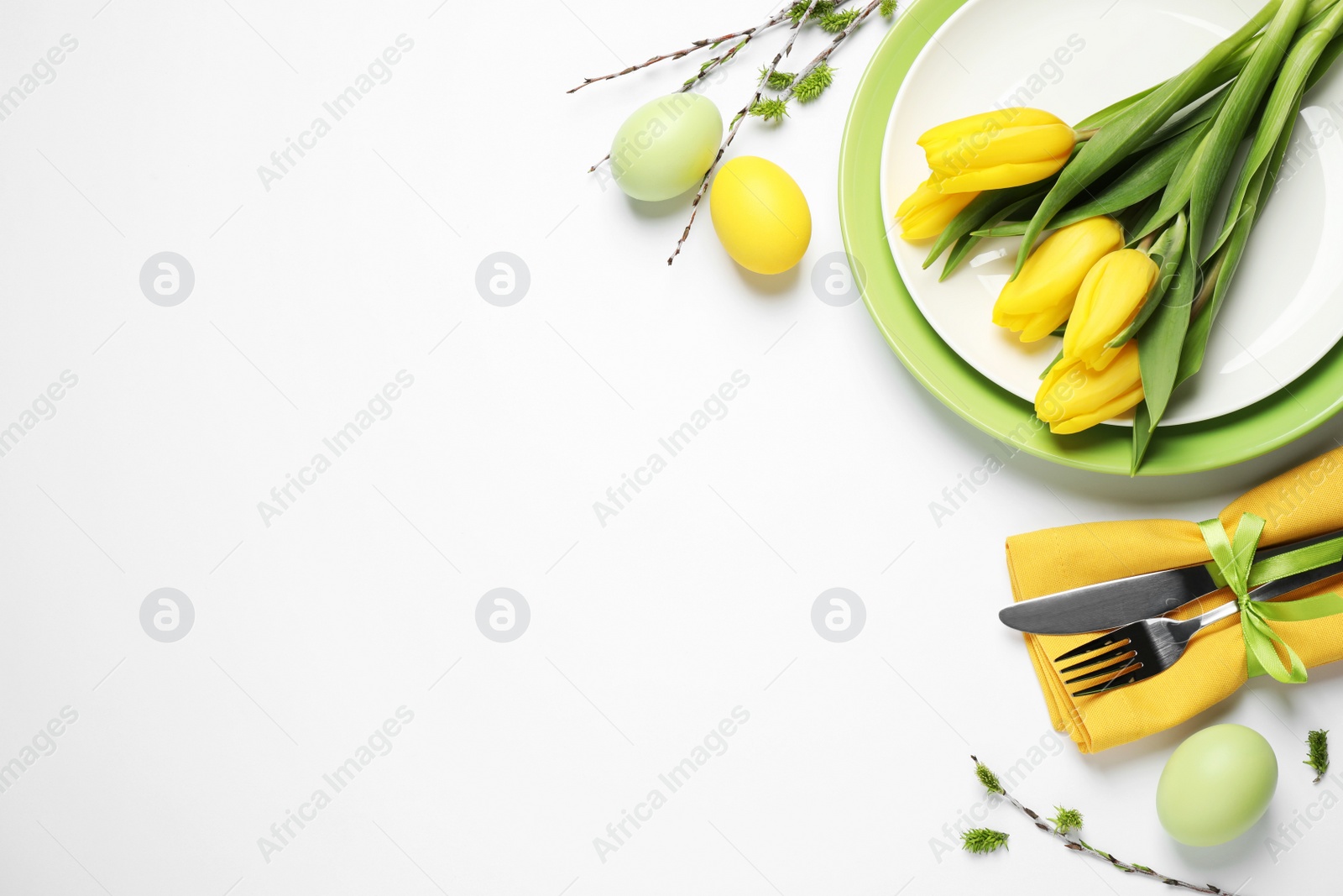 Photo of Festive Easter table setting with floral decor on white background, top view