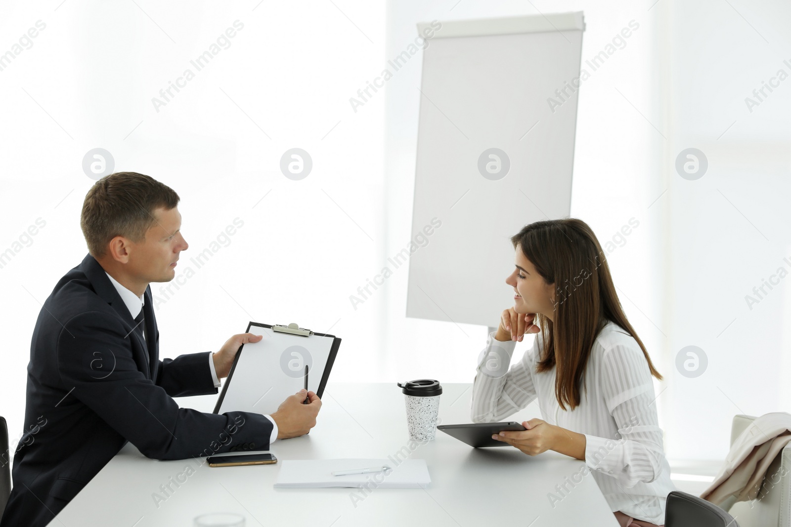 Photo of Office employees talking at table during meeting