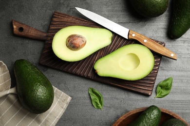 Delicious ripe avocados on grey table, flat lay