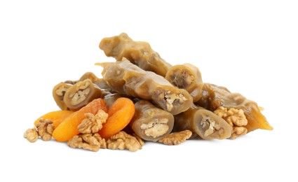 Photo of Delicious sweet churchkhelas with walnuts and dried apricots isolated on white
