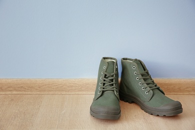 Photo of Pair of shoes on floor near wall