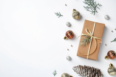 Photo of Flat lay composition with Christmas gift and festive decor on white background. Space for text