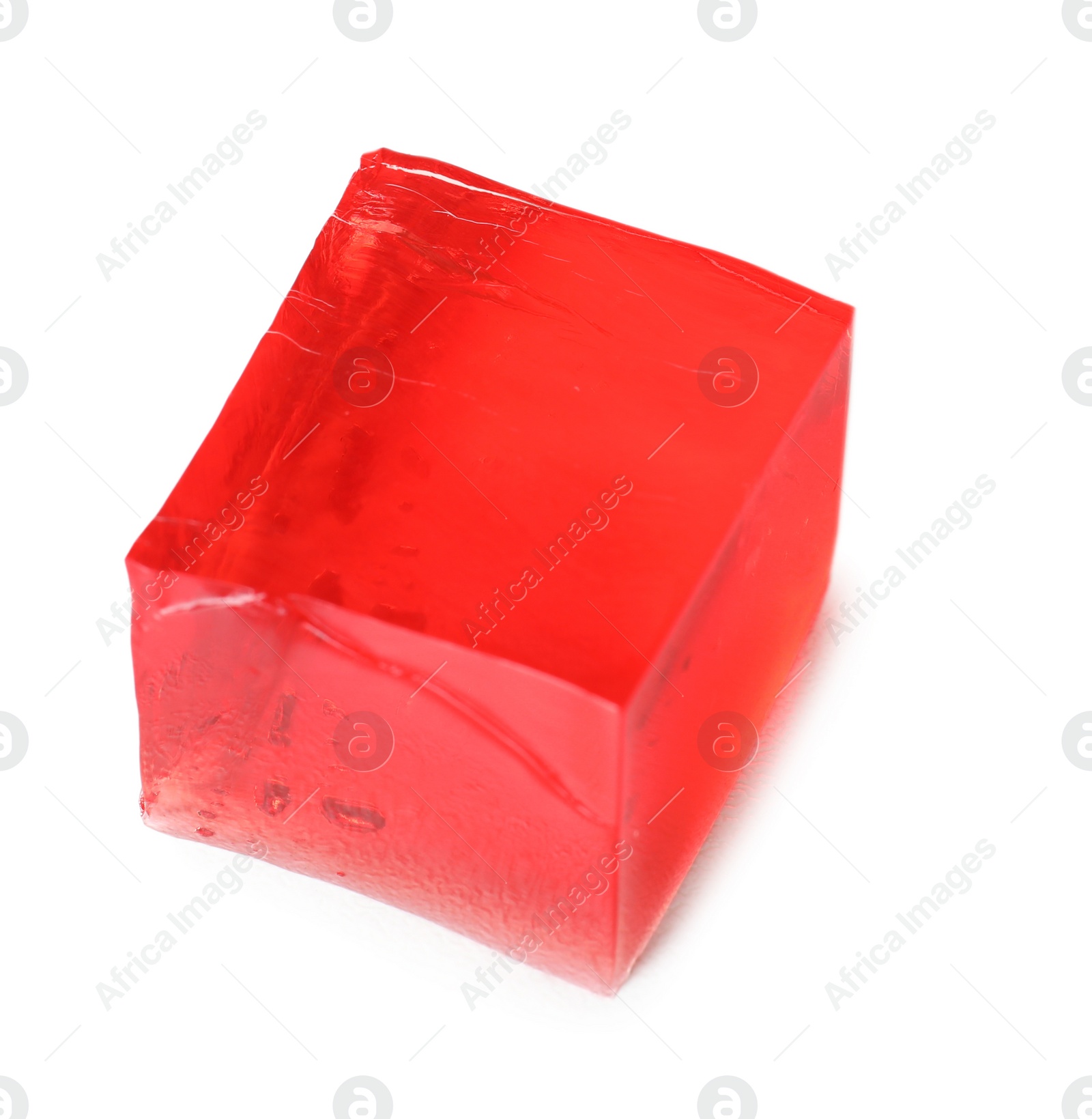 Photo of Delicious red jelly cube on white background