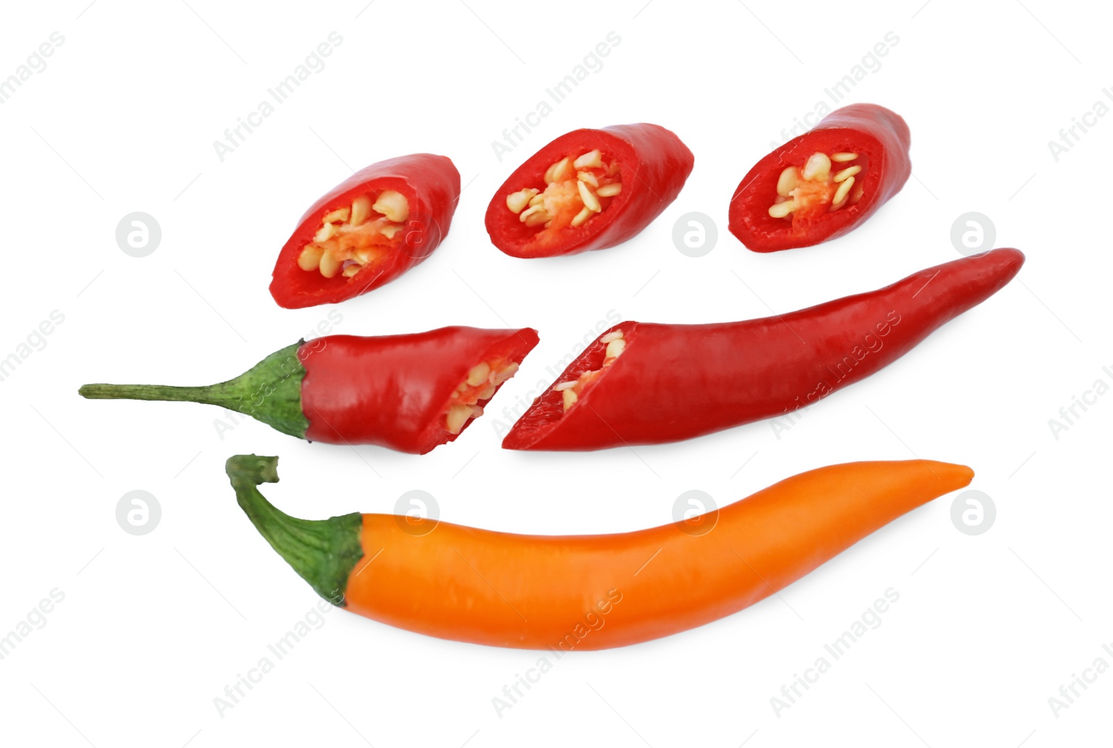 Photo of Cut and whole hot chili peppers on white background, flat lay