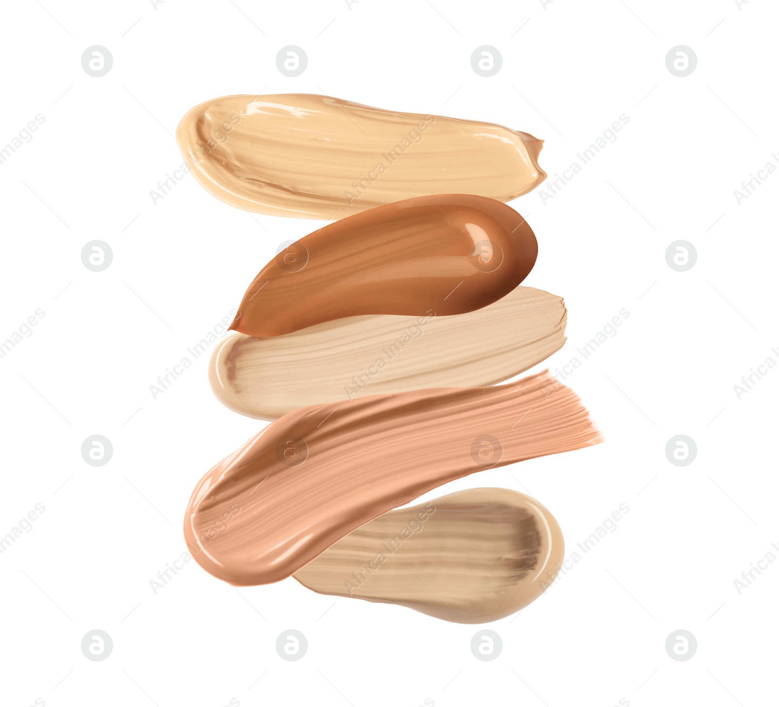 Image of Different shades of liquid skin foundation on white background, top view