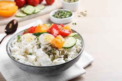 Photo of Fresh cottage cheese with vegetables, seeds and eggs in bowl on wooden table