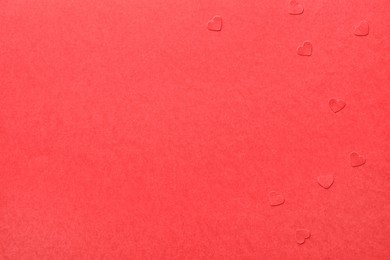 Paper hearts on red background, flat lay. Space for text