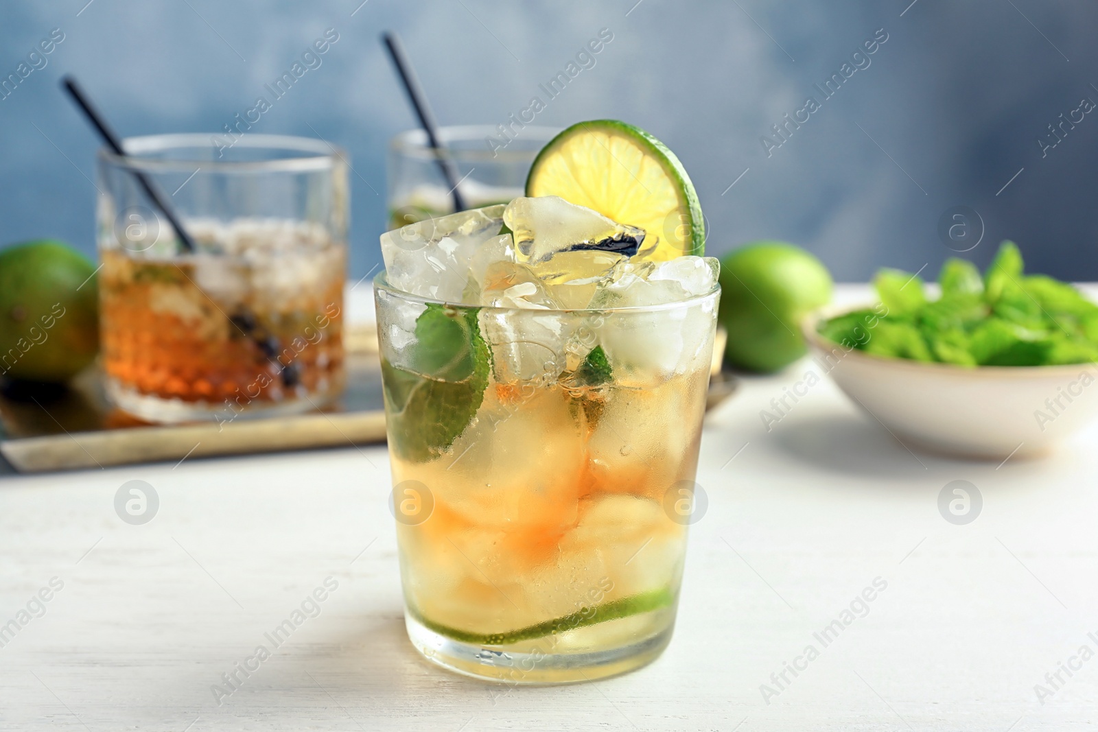 Photo of Glass of delicious mint julep cocktail on table