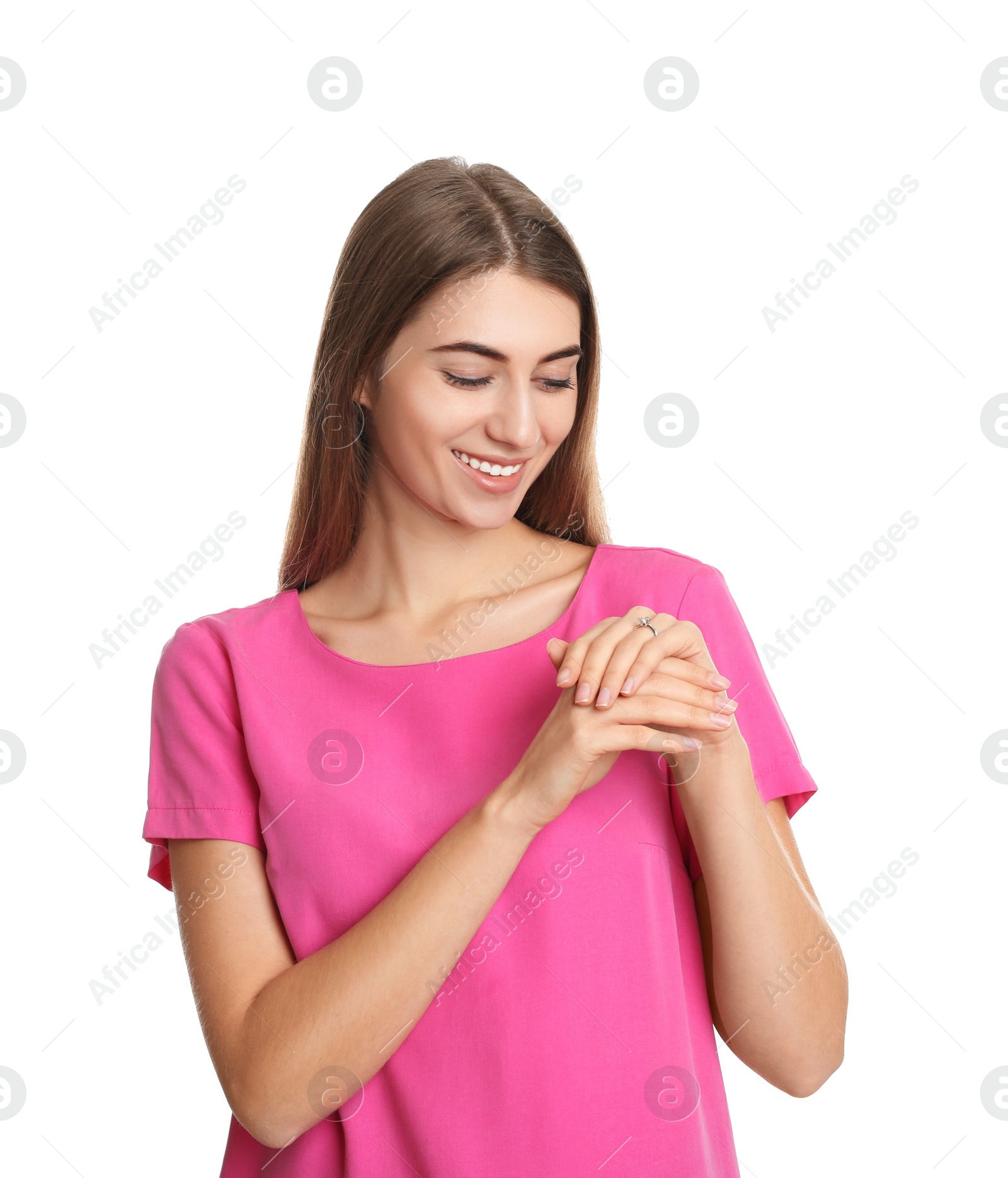 Photo of Happy young woman wearing beautiful engagement ring on white background