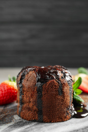 Photo of Delicious warm chocolate lava cake on marble board