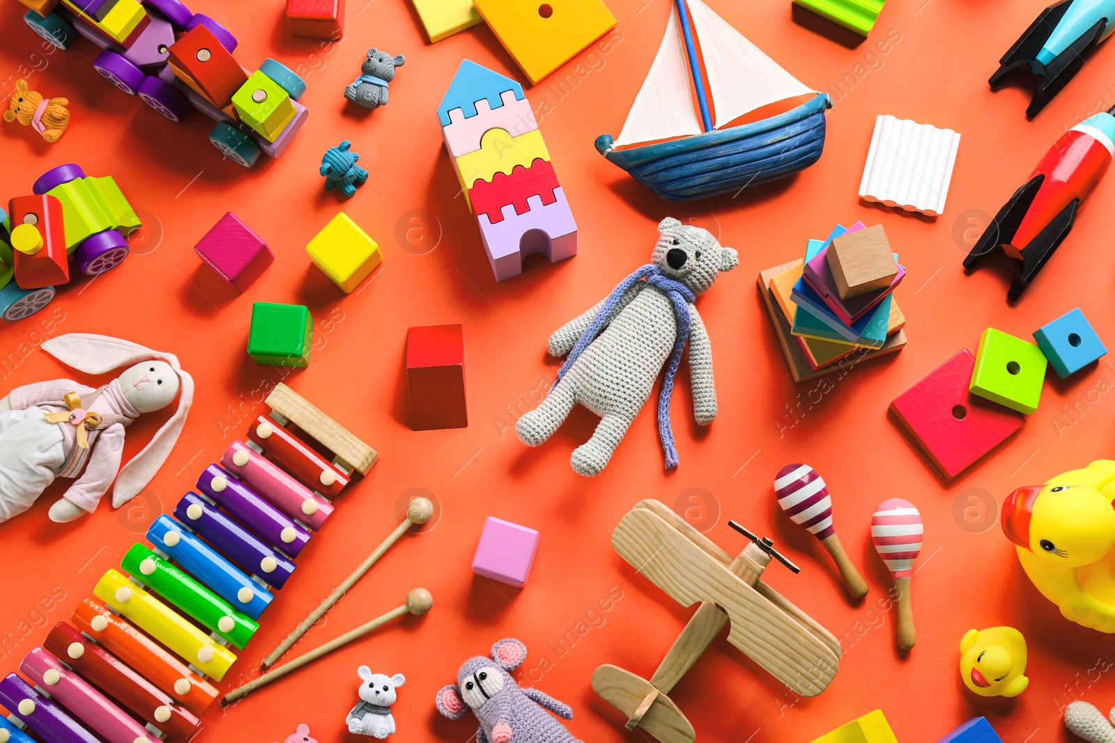 Photo of Different toys on orange background, flat lay