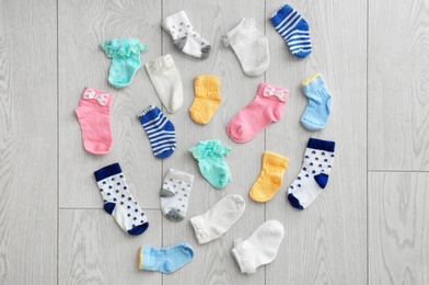 Photo of Flat lay composition with children's socks on wooden background