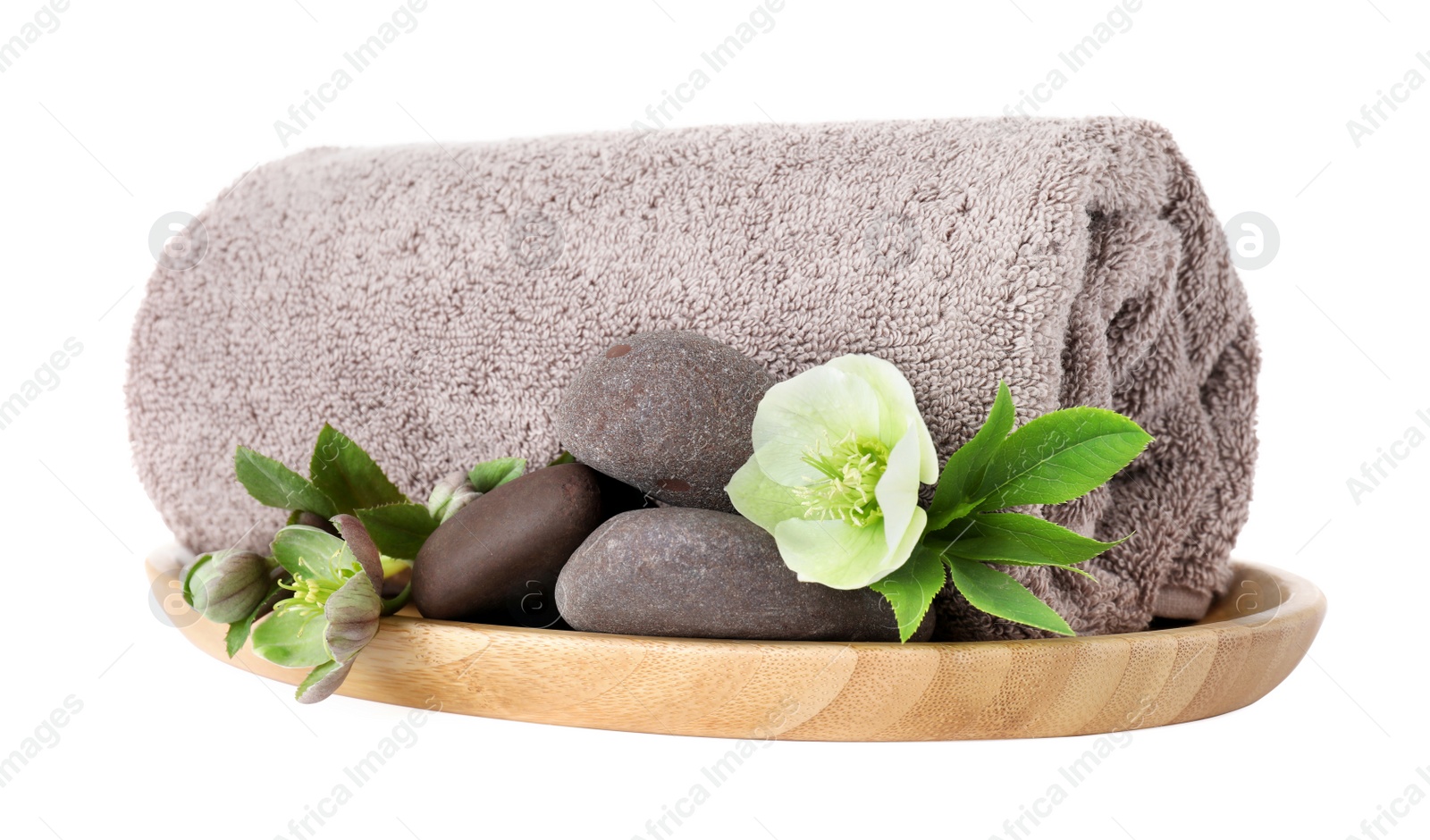 Photo of Wooden tray with towel, spa stones and flowers isolated on white