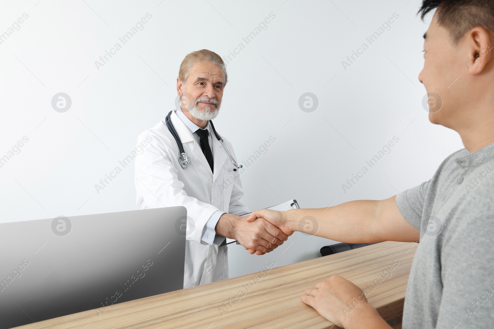 Photo of Doctor shaking hands with patient in hospital