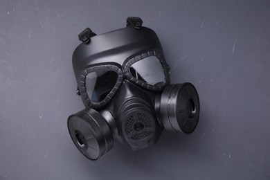 One gas mask on grey textured background, top view