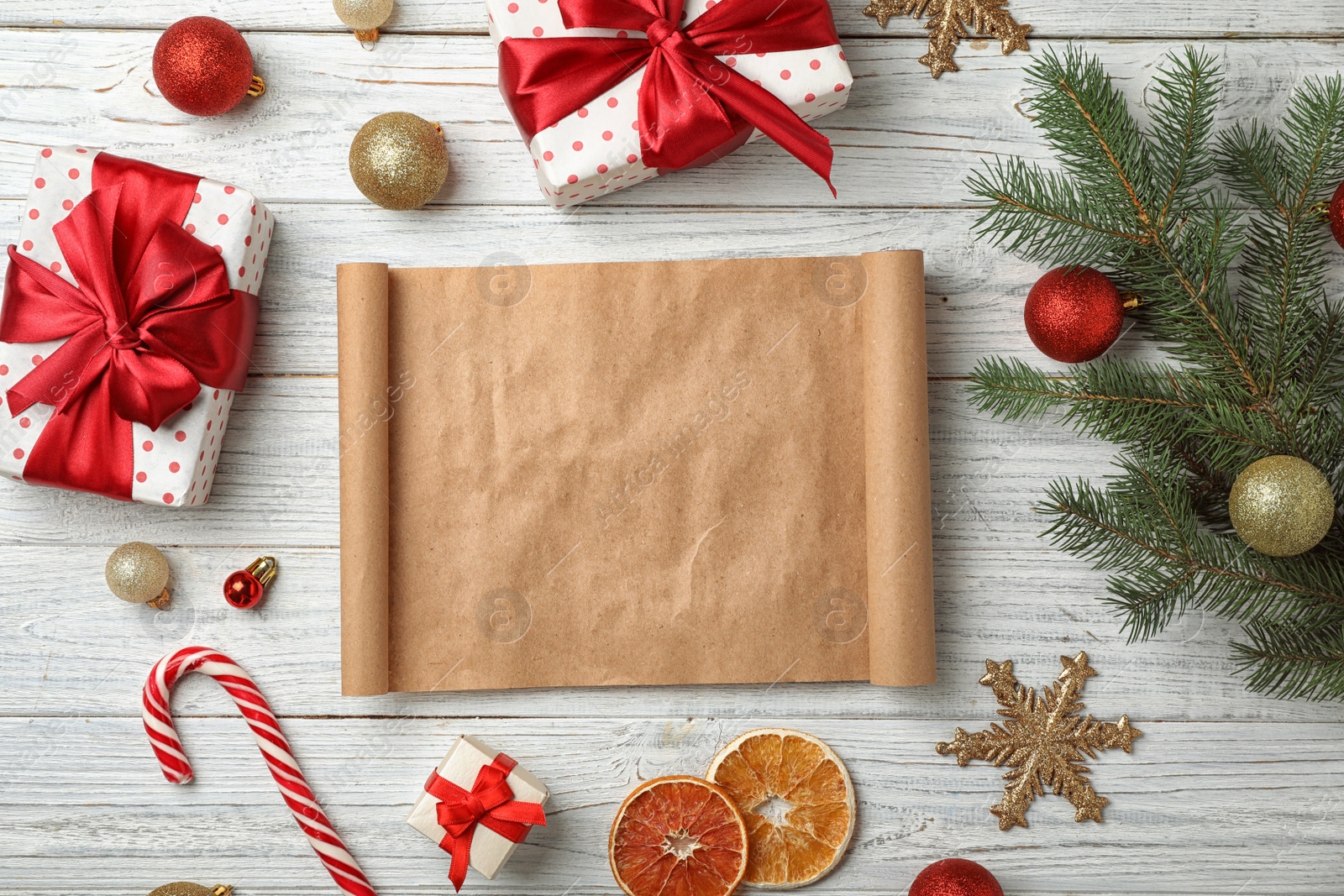 Photo of Flat lay composition with empty Santa's list and Christmas decoration on wooden background