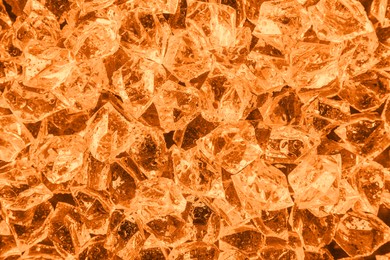 Image of Clear crushed ice as background, top view. Toned in orange