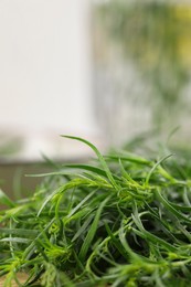 Photo of Fresh tarragon leaves on table, closeup. Space for text