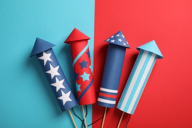 Photo of Firework rockets on color background, flat lay. Festive decor