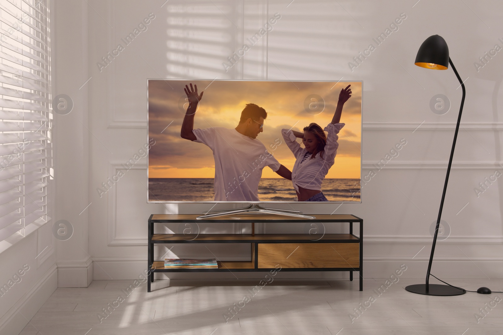 Image of Scene of romantic movie on TV in room