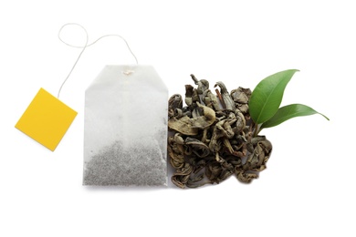 Tea bag and dry leaves on white background, top view