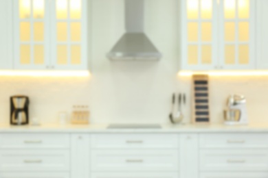 Photo of Blurred view of modern kitchen interior with stylish furniture