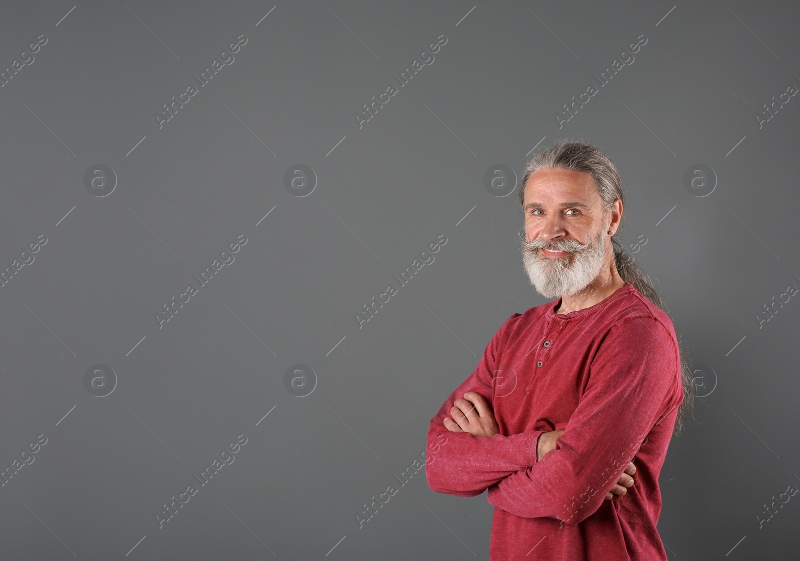 Photo of Portrait of handsome mature man on color background