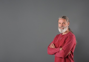 Portrait of handsome mature man on color background