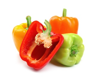 Photo of Whole and cut ripe bell peppers on white background