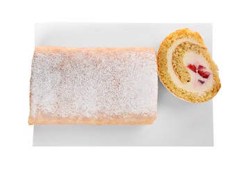 Delicious sponge cake roll with strawberries and cream on white background, top view