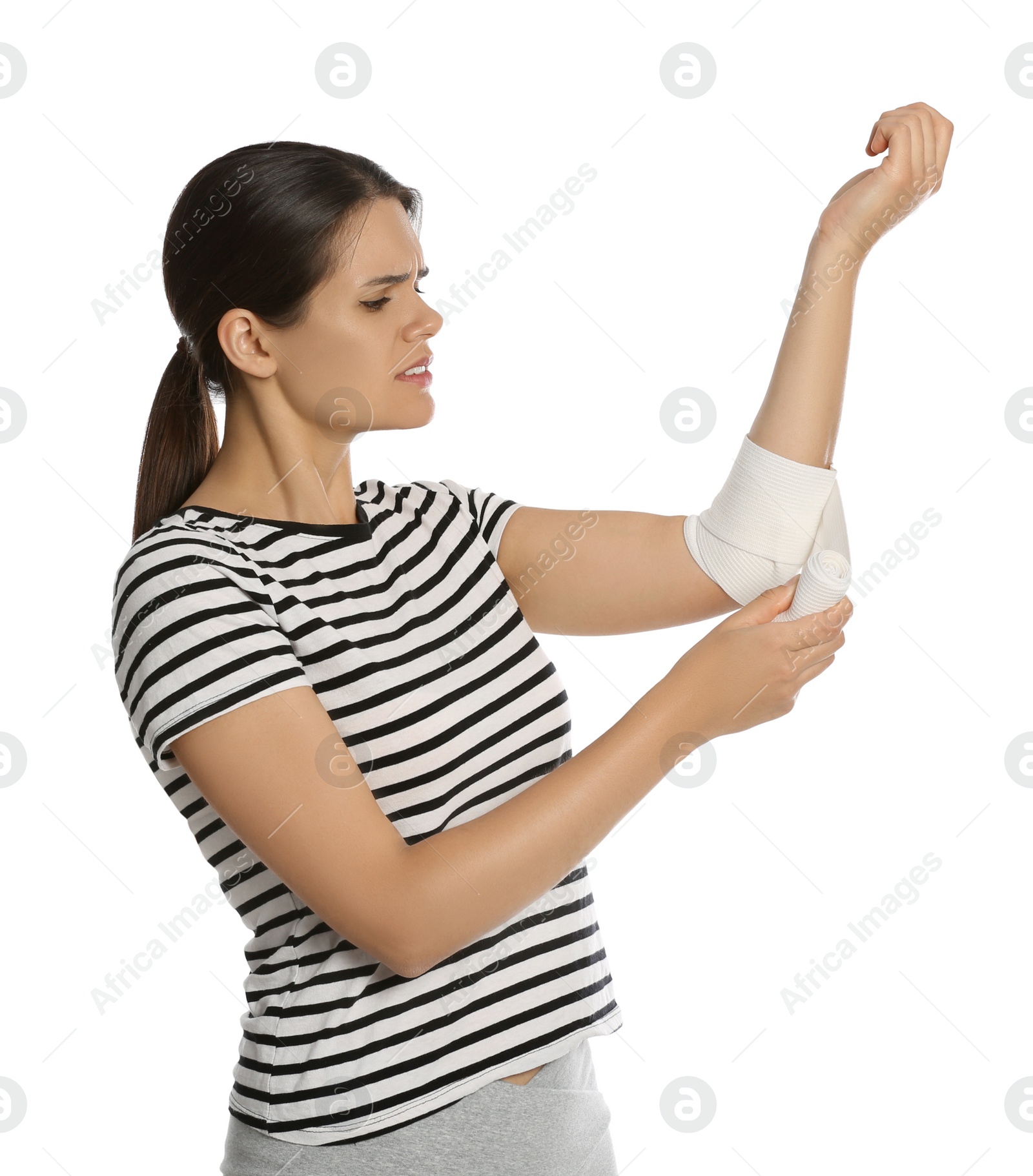 Photo of Young woman applying medical bandage onto arm against white background