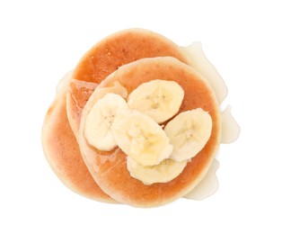 Photo of Delicious pancakes with banana slices and honey isolated on white, top view