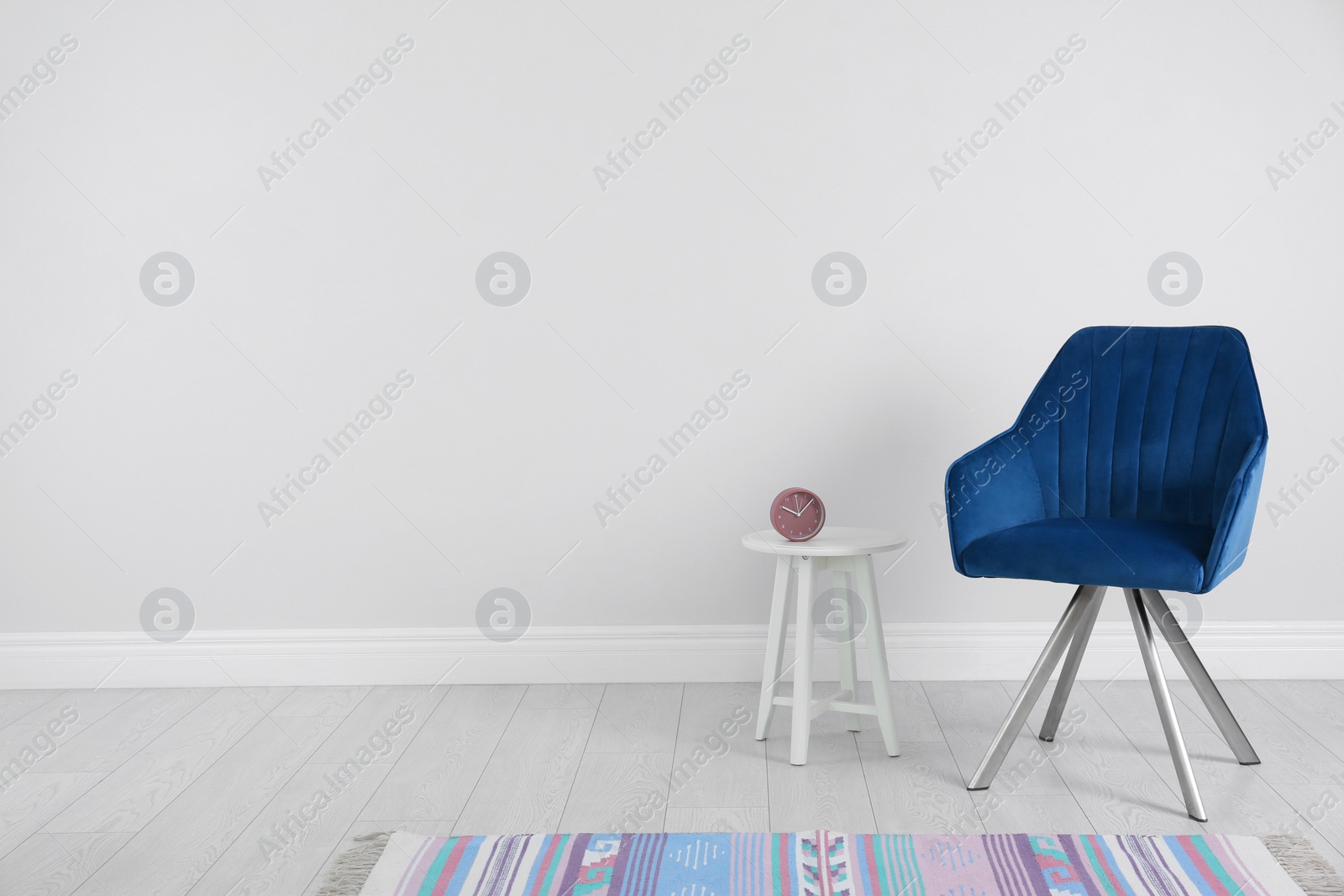 Photo of Blue modern chair, table and rug for interior design on wooden floor at white wall