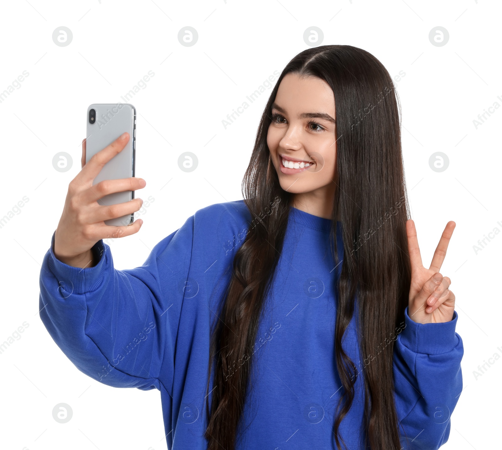 Photo of Teenage girl taking selfie on white background