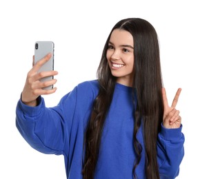 Teenage girl taking selfie on white background