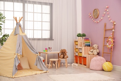 Modern nursery room interior with play tent for kids