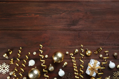 Flat lay composition with serpentine streamers on wooden background, space for text