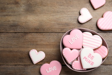 Photo of Heart shaped cookies on wooden table, flat lay with space for text. Valentine's day treat