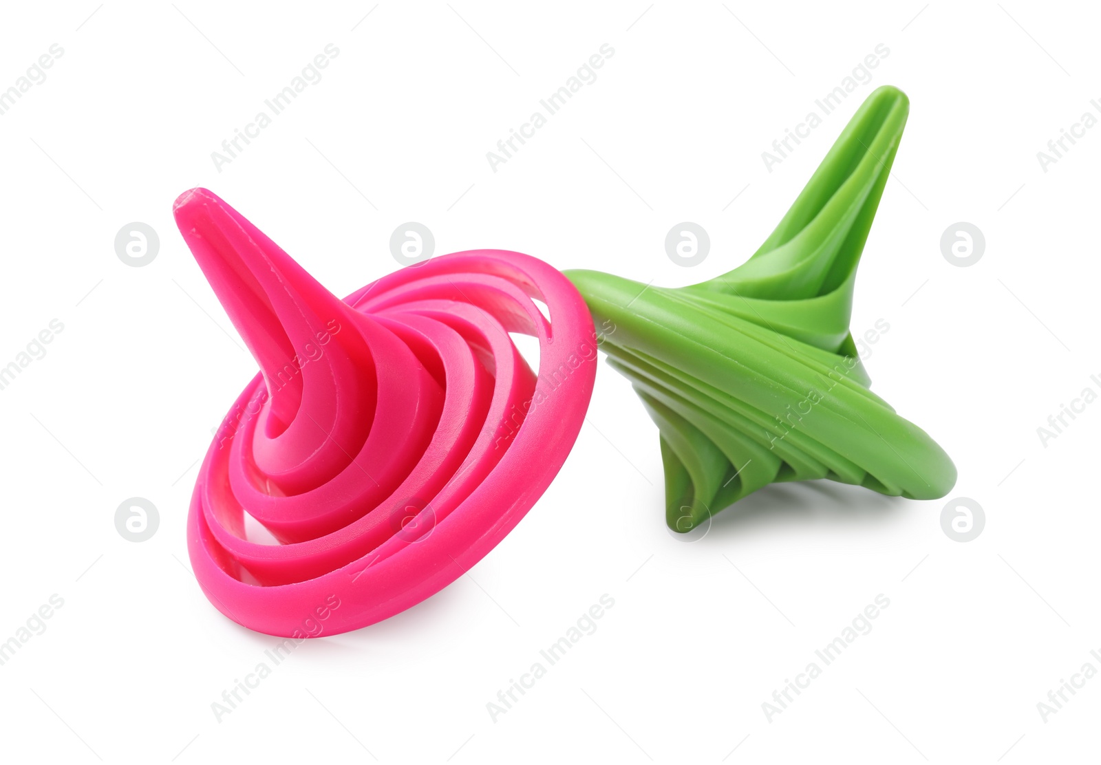 Photo of Green and pink spinning tops isolated on white