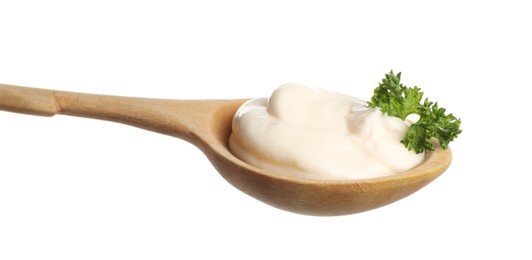 Wooden spoon with tasty mayonnaise and parsley isolated on white