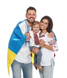 Photo of Happy family in national clothes with flag of Ukraine on white background