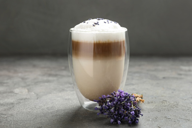 Photo of Delicious latte with lavender on grey table