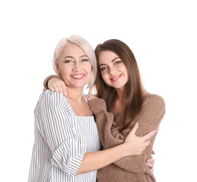 Portrait of young woman with her mature mother on white background