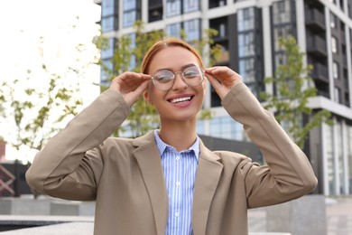 Portrait of beautiful woman in glasses outdoors