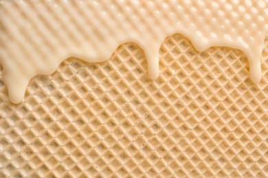 Photo of Hot white chocolate on wafer, closeup. Crispy food