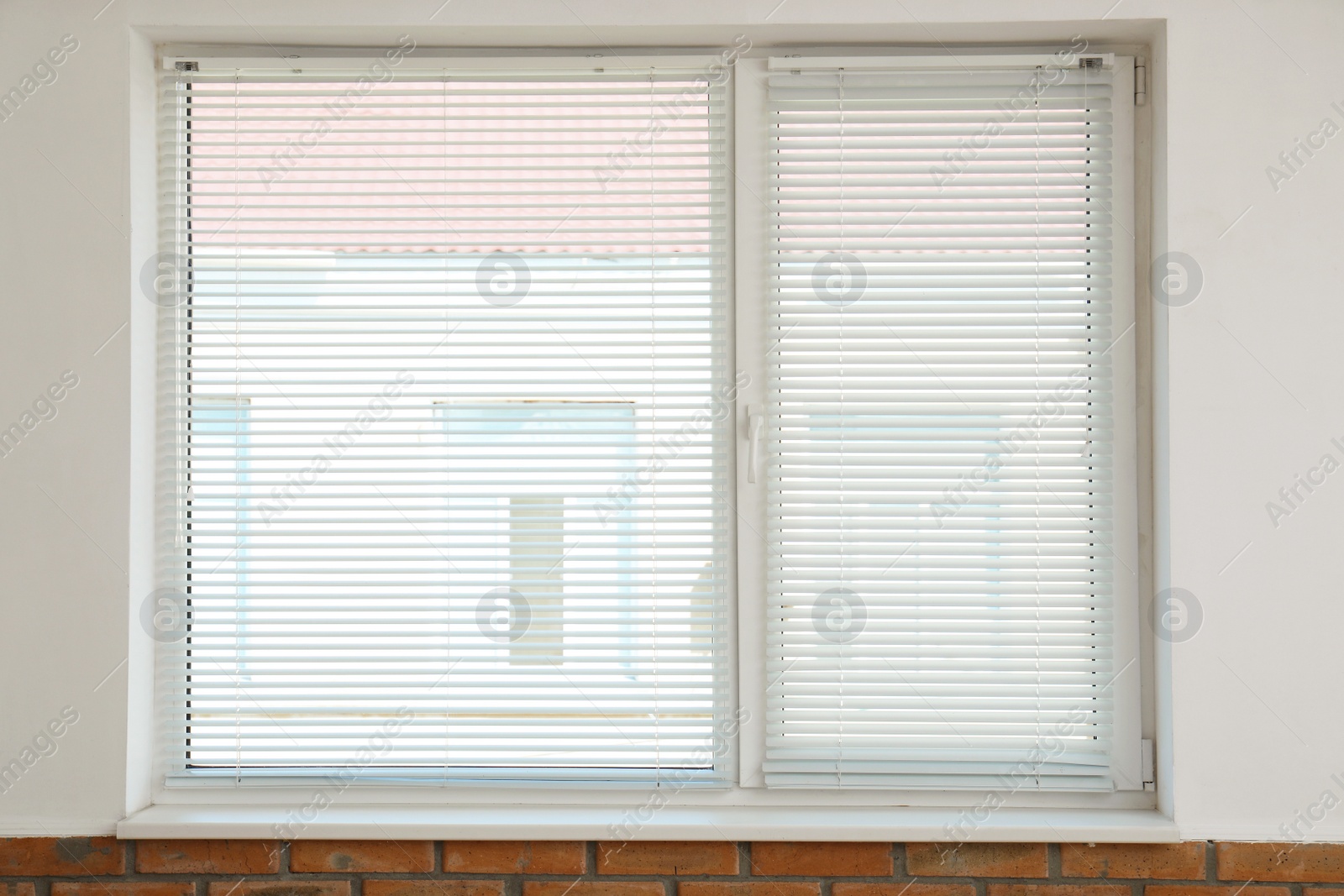 Photo of New modern window with blinds indoors. Home interior