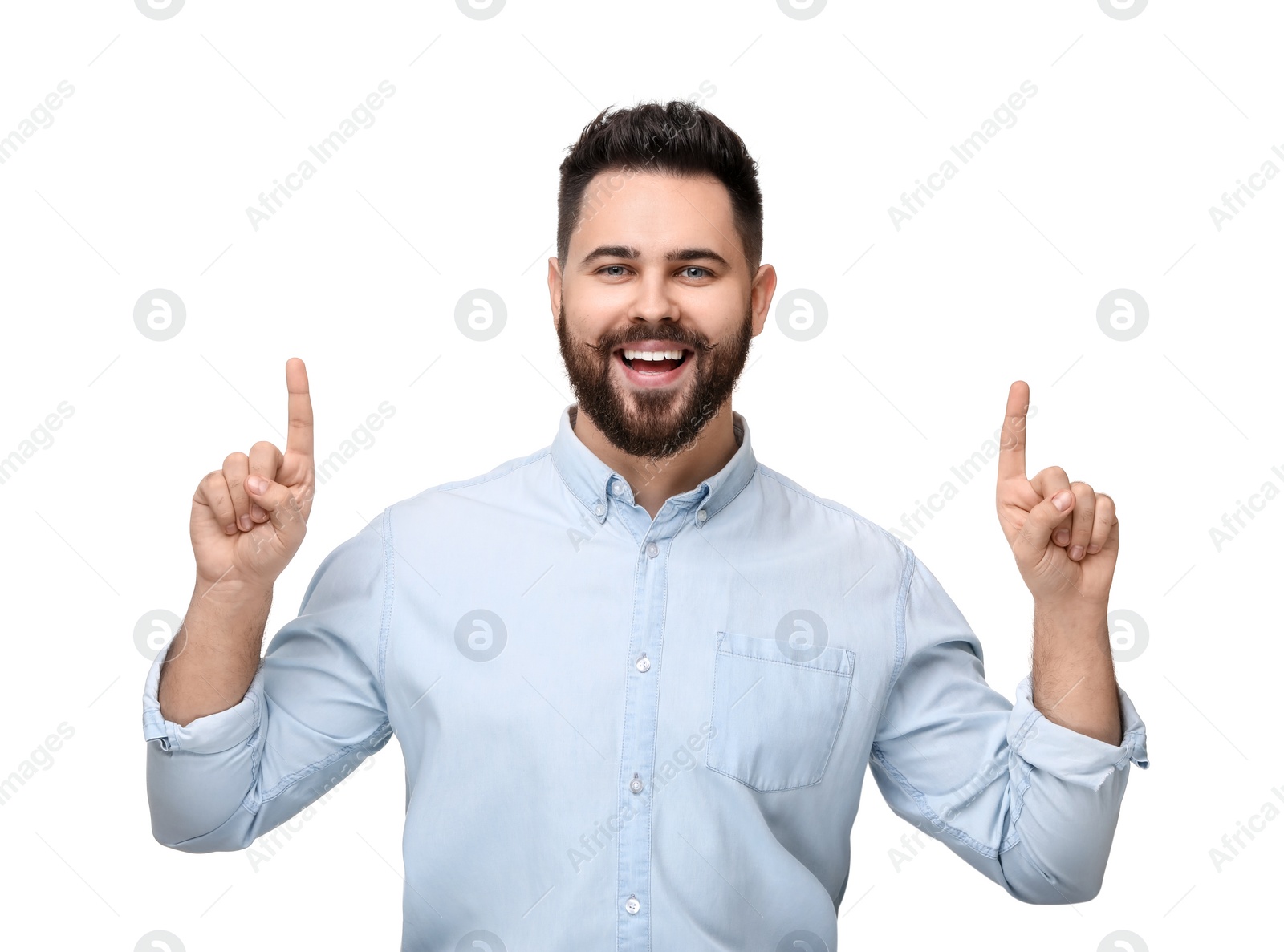 Photo of Happy young man with mustache pointing at something on white background